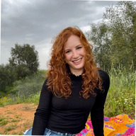 Sharon Samuel sitting in front of trees.